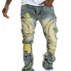 Men's patchwork fringe slightly flared stretch jeans in blue denim with distressed details and trendy rips.