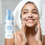 Happy woman using 120ml pore cleaning skin care product, applying foaming cleanser on her face.