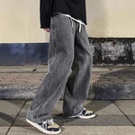 Men's straight loose American design jeans in gray, featuring a mid waist and drawstring for comfort.