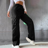 Beltless high waist wide leg straight trousers in black, styled with a white top and green bag.