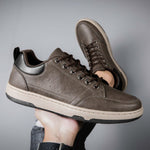 Brown casual low top men's fashion shoes with flat heel and round toe, ideal for leisure wear.