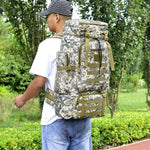 Camouflage outdoor mountaineering backpack in khaki with padded straps and three-dimensional pockets, ideal for rugged adventures.