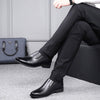 Men's black leather shoes paired with formal pants, showcasing a sleek and stylish business look.