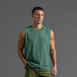 Men's plus size cotton sleeveless sports t-shirt in solid green, showcasing loose fit and casual style.