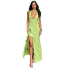 Woman wearing Deep-V Halterneck Lace-Up Maxi Dress with 3D flower detail in green, styled with asymmetric hem and lace-up ties.