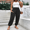 Elasticated high-waisted wide-legged niners in black, featuring long sleeves and pockets, worn casually outdoors.