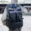 Fashion black backpack for men with large capacity, featuring adjustable straps and two front pockets.