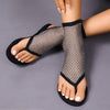 Rhinestone Mesh Thong Sandal featuring a flat design with a round toe and embellished mesh upper in black.