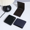 Fashion wallets in black, dark blue, and brown displayed beside a lamp, showcasing multifunctional card holder design.