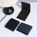 Fashion wallets in black, dark blue, and brown displayed beside a lamp, showcasing multifunctional card holder design.