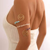 Gravel arm chain armband with colorful beaded spiral design on a model's arm.