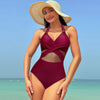 Halter-neck one-piece swimsuit in burgundy, featuring cross-strap design, perfect for beach vacations.
