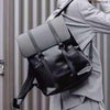 Stylish high-grade unisex black backpack with gray flap, perfect for travel and leisure activities.