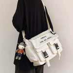 Large capacity men's casual messenger bag in white with plush toy keychain, suitable for daily use.