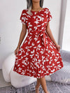 Pleated Leaf-Print Midi Dress in red with white flower print, round neck, and pleated skirt, perfect for summer.