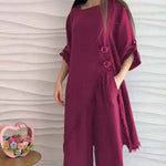 Loose-fitting wine red top with irregular hem and buttons, paired with wide-leg trousers, stylish women's fashion.