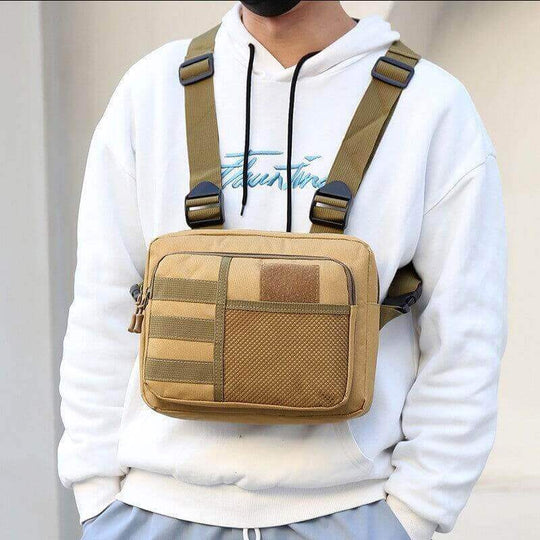 Men's casual outdoor tactical chest bag in khaki color, displayed on model wearing white hoodie.