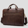 Men's leather briefcase in dark brown with handles and adjustable strap, ideal for business travel and everyday use.