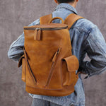 Men's large capacity brown leather backpack, solid color, ideal for leisure travel and stylish retro design.