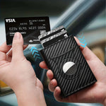 Men's metal card bag wallet in carbon fiber black, holding credit card, showcasing sleek design and genuine leather material.