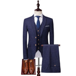 Men's slim fit navy blue suit with waistcoat and brown shoes, perfect for weddings and formal events.
