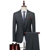 Men's three-piece slim fit suit in dark gray, featuring a blazer, trousers, and polished brown shoes for formal occasions.