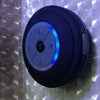 Mini waterproof LED speaker with Bluetooth, built-in mic, and high-quality sound on a textured background.