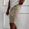 Light khaki multi-pocket men's shorts with drawstring, straight-leg style, perfect for work and sports.