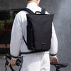 Stylish black men's computer backpack worn by a person in urban attire, perfect for students and travelers.
