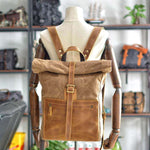 Stylish men's retro wax canvas backpack with leather accents, featuring a roll-top design and front zip pocket.