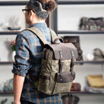 Stylish outdoor student backpack in khaki, featured on a man with glasses, perfect for travel and everyday use.