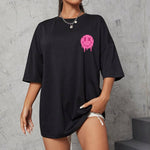 Trendy loose black women's short sleeve t-shirt featuring a pink emoji drawing, perfect for casual wear.