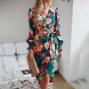 Elegant printed dress with V-neck and long sleeves in dark green floral pattern, perfect for autumn and winter.