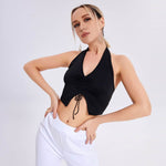 Model wearing a black sleeveless V-neck vest top, styled for spring and summer fashion.