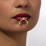 Stylish gold punk lip clip accessory worn on dark red lips, adding a bold geometric flair to lip decoration.