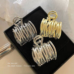 Small size headdress barrettes in gold, silver, and black colors displayed in a stylish box.