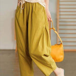 Solid color cotton high waist wide leg harem pants in vibrant yellow, perfect for casual and stylish looks.