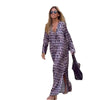 Woman wearing a Geometric Print Maxi Dress with long sleeves and carrying a bag, showcasing a folk-inspired design.