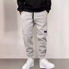 Casual gray drawstring trousers made of thick velveteen, perfect for leisure. Ideal for young, comfortable style.