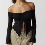 Black off-the-shoulder long sleeve top with ruched front, perfect for a stylish and sexy look.