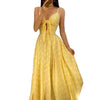 Yellow polka dot spaghetti strap dress with bow detail and flowing skirt.