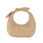 Vacation style bow straw handbag clutch in soft apricot color, dumpling shape, perfect for summer outings.