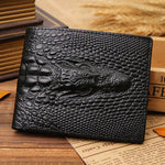 Vintage black crocodile pattern genuine leather men's coin purse on wooden surface.