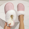 Stylish pink plush slippers with fluffy white trim, perfect for cozy indoor wear at home.