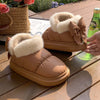 Cozy brown winter ankle boots with furry lining and bow detail, perfect for warm and stylish outdoor wear.