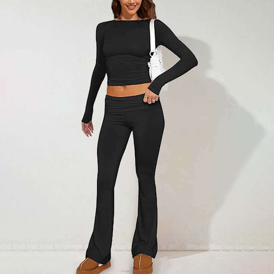Stylish woman in black long sleeve fitted suit, showcasing color block design and casual elegance.