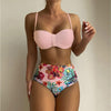 Women's pink floral print bikini set with spaghetti straps, high-waisted bottoms, perfect for summer swimming.
