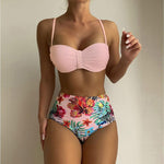 Women's pink floral print bikini set with spaghetti straps, high-waisted bottoms, perfect for summer swimming.