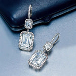 Elegant women's French-style geometric zircon earrings in white gold color, showcasing quadrilateral shapes.