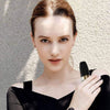 Woman holding a black USB rechargeable women's hair remover, showcasing its sleek design and ease of use.